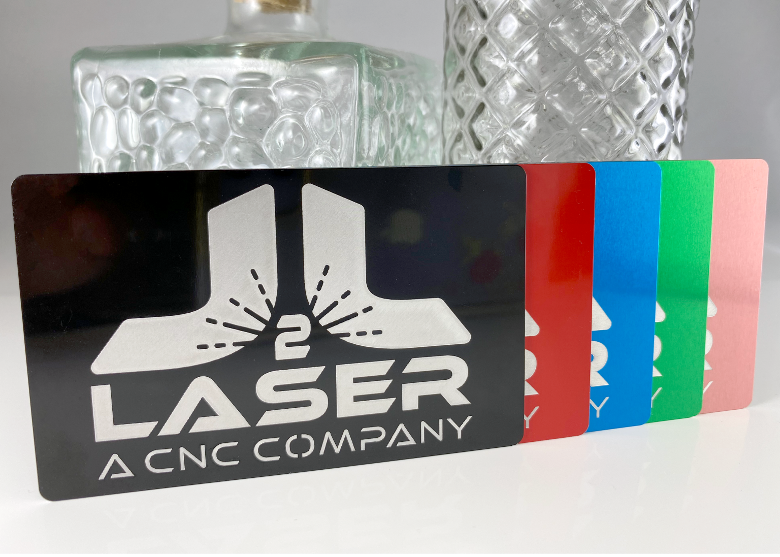 Black, red, blue, green and pink engraved metal cards