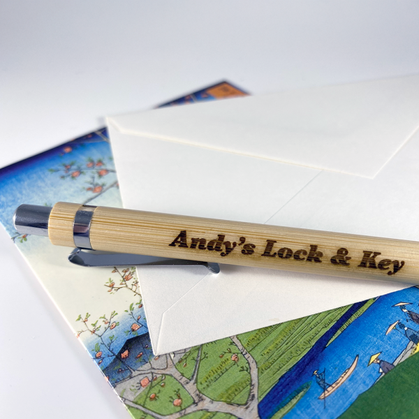 Wooden engraved pen on a greeting card and envelope